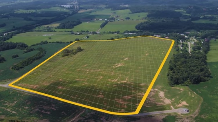 Aerial view of a field with its property boundary outlined in yellow